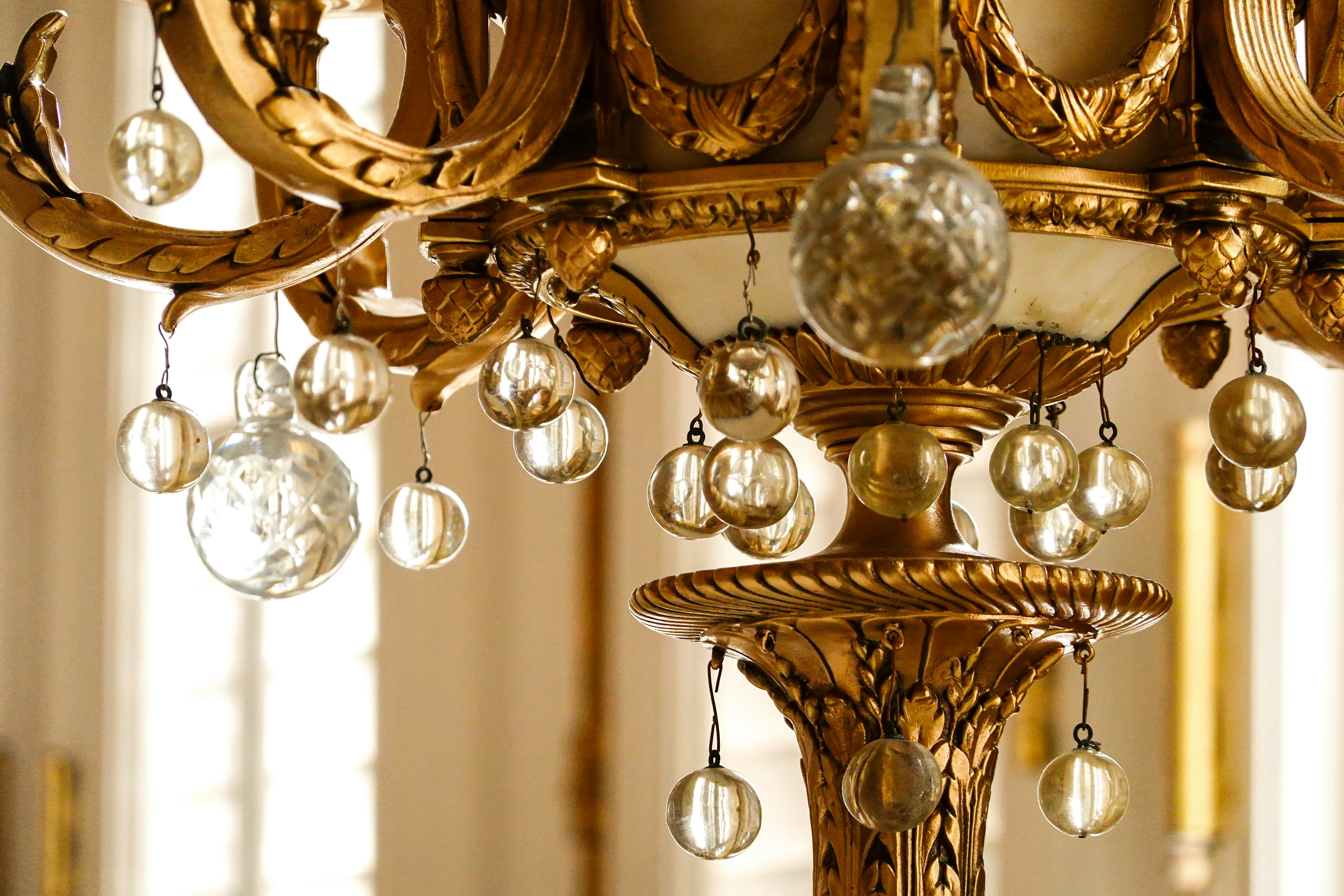 gold and white chandelier turned on in tilt shift lens